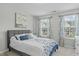 Bright bedroom featuring two large windows, and bed with blue and white patterned bedding at 2801 Landon Ridge Dr, New Hill, NC 27562