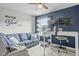 Bedroom featuring blue accent wall, modern desk, plush sofa, and large window for natural light at 2801 Landon Ridge Dr, New Hill, NC 27562