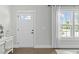 Bright entryway featuring a white front door with glass panels and a hardwood floor at 2801 Landon Ridge Dr, New Hill, NC 27562