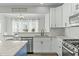 Bright kitchen with white cabinetry, granite countertops, and stainless steel appliances at 2801 Landon Ridge Dr, New Hill, NC 27562