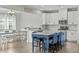 Bright kitchen with white cabinets, granite countertops, and blue island with seating at 2801 Landon Ridge Dr, New Hill, NC 27562