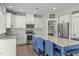 Modern kitchen with white cabinets, stainless steel appliances and island with seating at 2801 Landon Ridge Dr, New Hill, NC 27562
