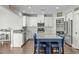 Well-lit kitchen featuring stainless steel appliances, white cabinets, and a blue island at 2801 Landon Ridge Dr, New Hill, NC 27562
