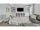 Living room showcasing custom built-ins, a large TV, and comfortable seating at 2801 Landon Ridge Dr, New Hill, NC 27562
