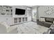 Living room showcasing custom built-ins, a large TV, and comfortable seating at 2801 Landon Ridge Dr, New Hill, NC 27562