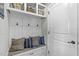 Mudroom with storage lockers, hooks and a bench with decorative pillows and overhead shelves at 2801 Landon Ridge Dr, New Hill, NC 27562