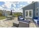 Beautiful stone patio with outdoor dining and seating and view of backyard at 2801 Landon Ridge Dr, New Hill, NC 27562