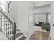 Staircase with dark wood steps leading to a doorway, with a view into the living room at 2801 Landon Ridge Dr, New Hill, NC 27562