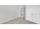 Bright bedroom with plush carpet, ensuite bath access, and large closet at 2904 Great Lawn Rd, Apex, NC 27502