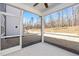 Spacious screened porch with views of the backyard and surrounding woods at 293 Beacon Dr, Pittsboro, NC 27312