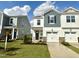 New construction townhome with attached garage, stone accents and tidy front lawn at 30 Twin Birch Dr, Angier, NC 27501