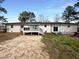 The backyard features a large, freshly stained deck, with a level yard surrounded by mature trees at 300 Perry St, Rolesville, NC 27571