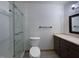 Modern bathroom featuring a glass enclosed shower, toilet, and vanity with sleek dark cabinetry at 300 Perry St, Rolesville, NC 27571