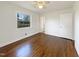 Bright and airy bedroom featuring hardwood floors and large windows at 300 Perry St, Rolesville, NC 27571
