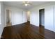 Spacious bedroom with gleaming hardwood floors, white walls, and a closet for ample storage at 300 Perry St, Rolesville, NC 27571