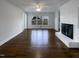 Bright living room featuring hardwood floors, a fireplace, and natural light from large windows at 300 Perry St, Rolesville, NC 27571