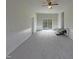 Inviting living room with plush carpeting, wainscoting, and sliding doors to a backyard deck at 300 Perry St, Rolesville, NC 27571