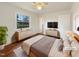 Main bedroom with a large window, hardwood floors and a neutral color palette at 300 Perry St, Rolesville, NC 27571