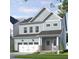 Charming two-story home with a covered front porch, manicured lawn, and an attached garage at 304 Beacon Dr, Pittsboro, NC 27312