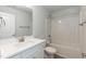 Bathroom featuring white cabinetry, a large mirror, and a tub with shower at 316 Hopewell Branch Ct, Smithfield, NC 27577