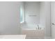 Bright bathroom with a soaking tub and a window to let in lots of natural light at 316 Hopewell Branch Ct, Smithfield, NC 27577