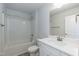 Bathroom featuring white cabinetry, a large mirror, and a tub with shower at 316 Hopewell Branch Ct, Smithfield, NC 27577