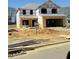 New home under construction featuring a two car garage with a worker onsite at 316 Hopewell Branch Ct, Smithfield, NC 27577