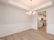 Bright dining room with classic molding, chandelier, and luxury vinyl plank flooring at 316 Hopewell Branch Ct, Smithfield, NC 27577