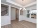 Open dining room with modern chandelier, molding, and luxury vinyl plank flooring at 316 Hopewell Branch Ct, Smithfield, NC 27577