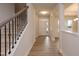 Hallway with staircase, neutral paint, luxury vinyl plank flooring, and natural light at 316 Hopewell Branch Ct, Smithfield, NC 27577