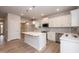 Bright kitchen features white cabinets, stainless appliances, and a large center island with breakfast bar at 316 Hopewell Branch Ct, Smithfield, NC 27577