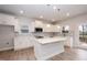 Bright kitchen featuring white cabinets, stainless appliances, and large center island at 316 Hopewell Branch Ct, Smithfield, NC 27577