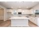 Kitchen with white cabinets, stainless appliances, large center island, and luxury vinyl plank flooring at 316 Hopewell Branch Ct, Smithfield, NC 27577