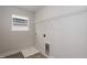 The laundry room features vinyl flooring, a window, and washer/dryer hookups at 316 Hopewell Branch Ct, Smithfield, NC 27577