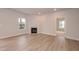 Bright living room with a fireplace, a window view, and light-colored wood-look floors at 316 Hopewell Branch Ct, Smithfield, NC 27577