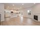Large open-concept living space with a fireplace, kitchen, and island with white cabinets at 316 Hopewell Branch Ct, Smithfield, NC 27577