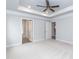 Spacious primary bedroom with neutral carpet, two closets, ceiling fan, and ensuite bathroom at 316 Hopewell Branch Ct, Smithfield, NC 27577