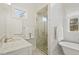 Bathroom featuring glass shower, marble countertop, and soaking tub at 321 Nottingham Dr, Chapel Hill, NC 27517