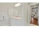 Bright bathroom with white cabinets, marble countertops, and classic finishes at 321 Nottingham Dr, Chapel Hill, NC 27517