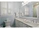 Bathroom with marble vanity, custom window shutters, and shower at 321 Nottingham Dr, Chapel Hill, NC 27517