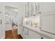 Charming butler's pantry with marble countertops, glass-front cabinets, and a stylish brass faucet at 321 Nottingham Dr, Chapel Hill, NC 27517