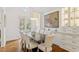 Bright and spacious dining room with a modern chandelier, custom cabinets, and ample seating for memorable gatherings at 321 Nottingham Dr, Chapel Hill, NC 27517