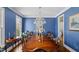 Formal dining room featuring a large wood table, chandelier, and blue wallpaper at 321 Nottingham Dr, Chapel Hill, NC 27517