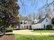 Charming two-story home with a well-manicured lawn, mature trees, and a three-car garage at 321 Nottingham Dr, Chapel Hill, NC 27517