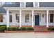 Inviting front porch featuring classic white columns, brick steps, and two rocking chairs at 321 Nottingham Dr, Chapel Hill, NC 27517