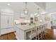 Elegant kitchen with custom white cabinets, marble countertops, stainless appliances, and a central island with seating at 321 Nottingham Dr, Chapel Hill, NC 27517