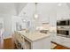 Bright, modern kitchen featuring a large island, stainless steel appliances, and white cabinetry at 321 Nottingham Dr, Chapel Hill, NC 27517