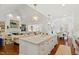 Open-concept kitchen with a large island, marble countertops, and seamlessly integrated into the living and dining areas at 321 Nottingham Dr, Chapel Hill, NC 27517
