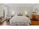 Bright main bedroom with hardwood floors, decorative pillows, and classic wood furniture at 321 Nottingham Dr, Chapel Hill, NC 27517