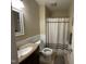 Bathroom featuring a granite vanity and shower with a brown and white curtain at 321 Willowood Dr, Henderson, NC 27536